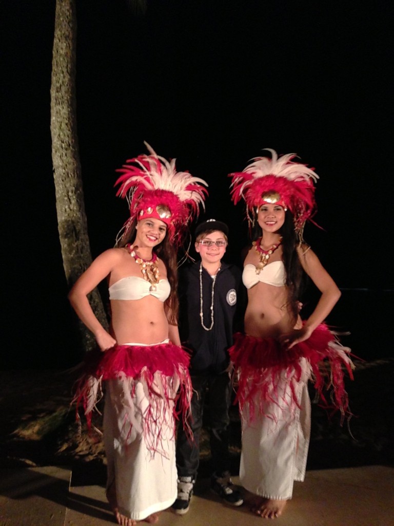 Ladies of the luau in Tahitian finery, with appreciative guest