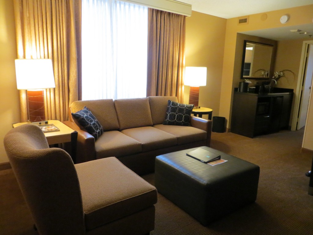 The seating area of a living room of a suite at Embassy Suites Chicago Downtown