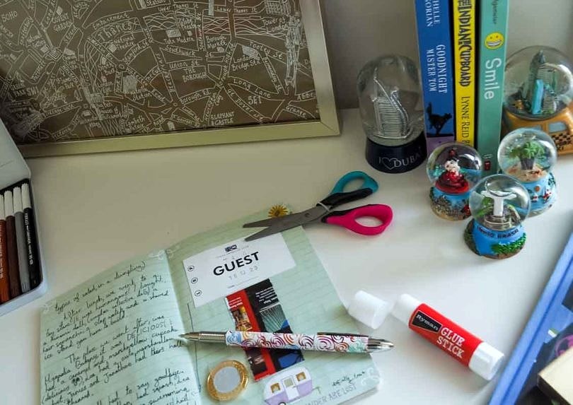 A collection of snow globes from around the world and a child's travel journal