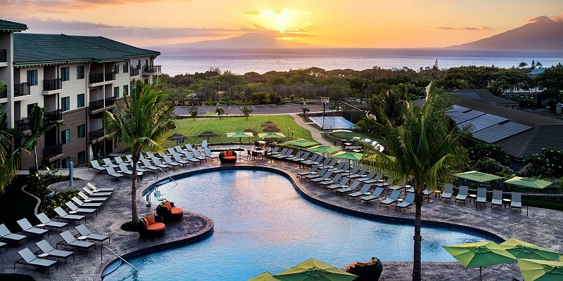 View of Residence Inn Maui's pool with the ocean and Lanai in the distance 