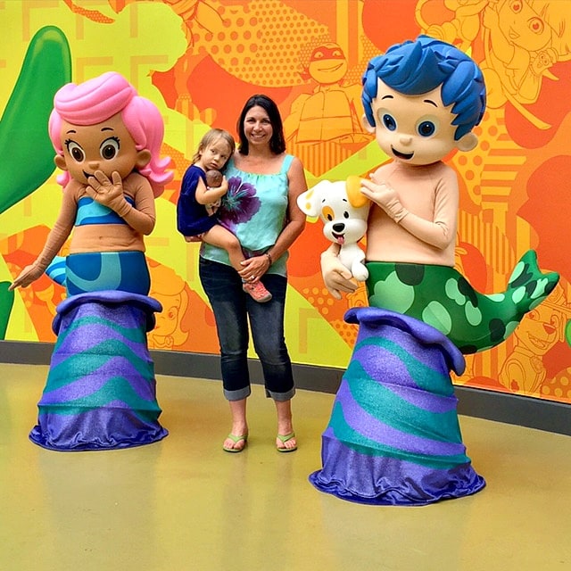 The Unofficial Guide to Mall of America's author, Beth Blair, with her youngest daughter posing with Nick characters in Nickelodeon Universe 