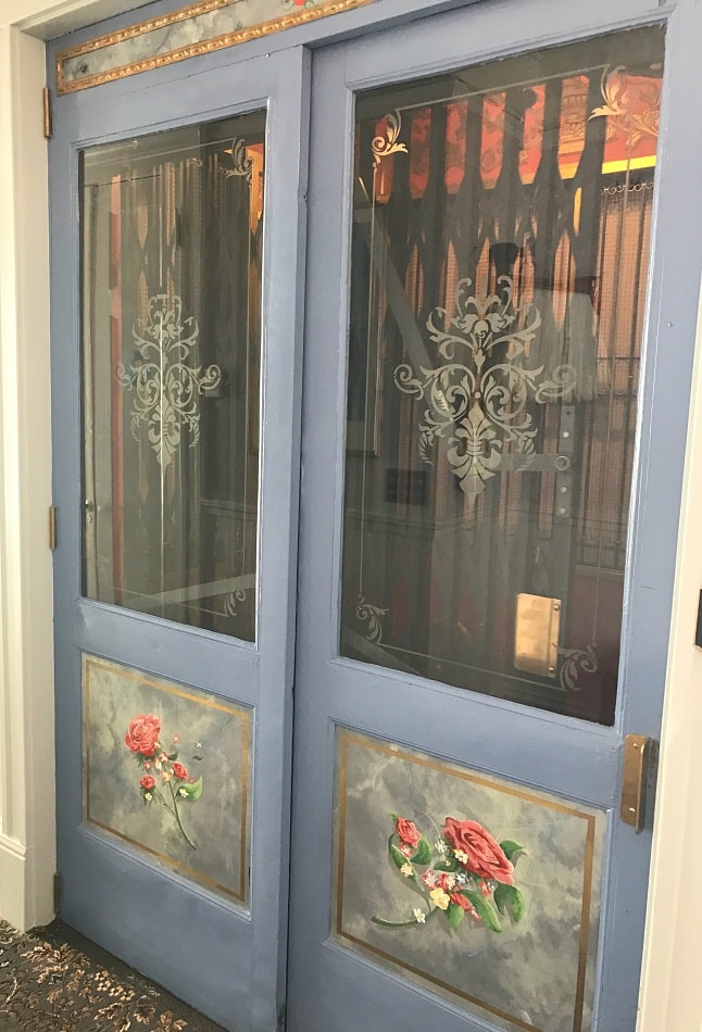 An old world elevator deposits guests on different floors of Cornell Hotel de France