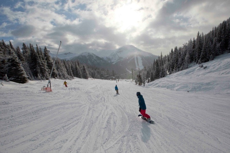 The Saucy Travel Mama boards down the back side of Lake Louise Ski Resort ~ Why Ski Lake Louise with Kids