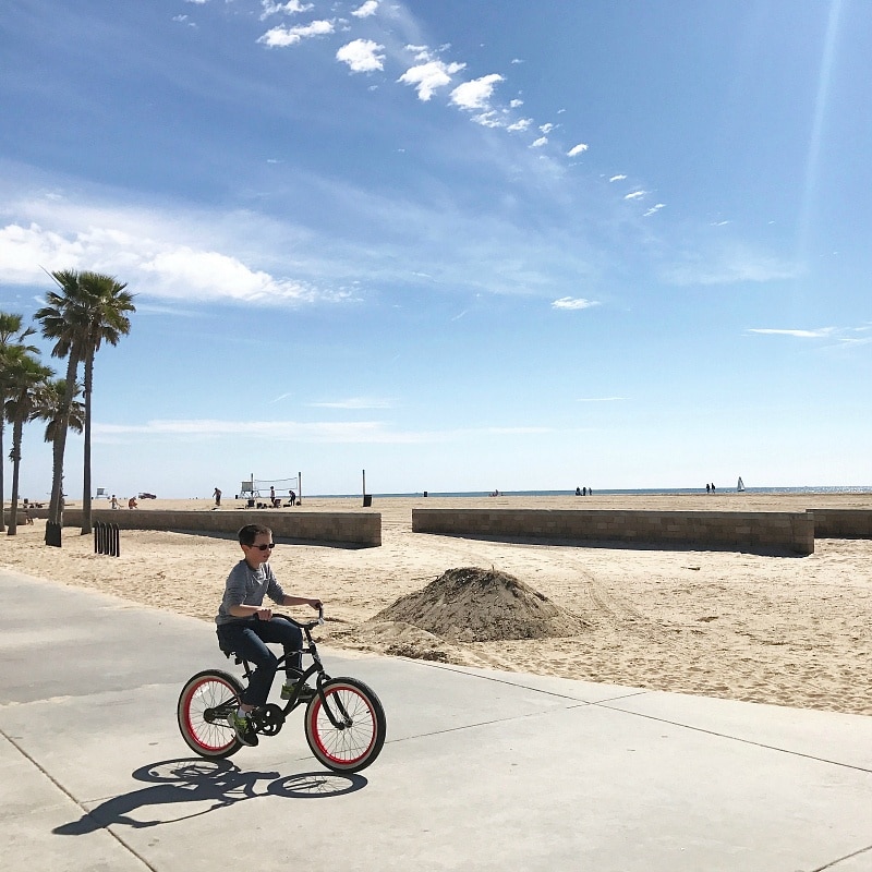 Rent bicycles to explore the beach boardwalk in Huntington Beach with kids