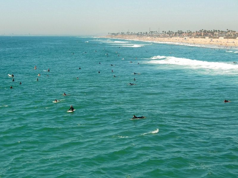 Surfers waiting to catch a wave in Huntington Beach in Orange County