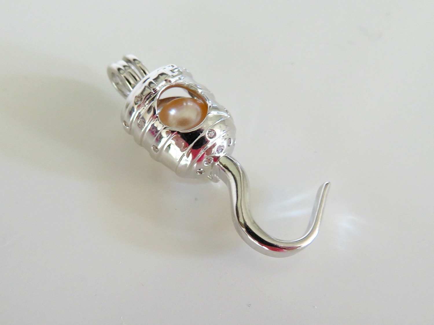 A pirate's hook pearl cage from AOS Design