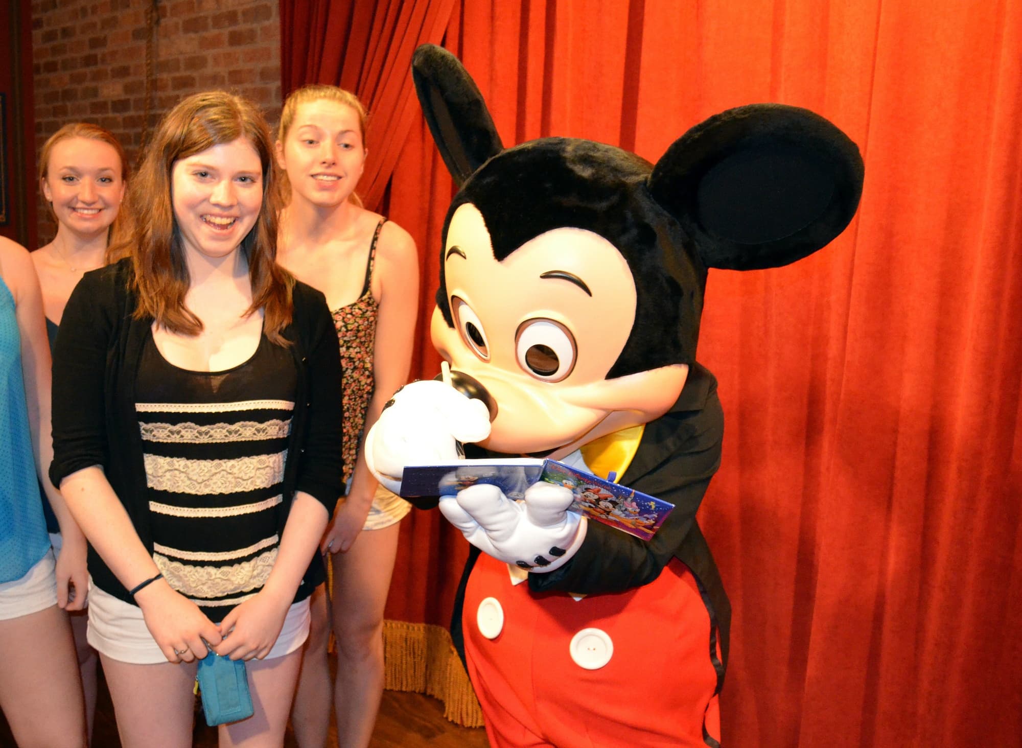 Teens meeting Mickey Mouse at Disney World