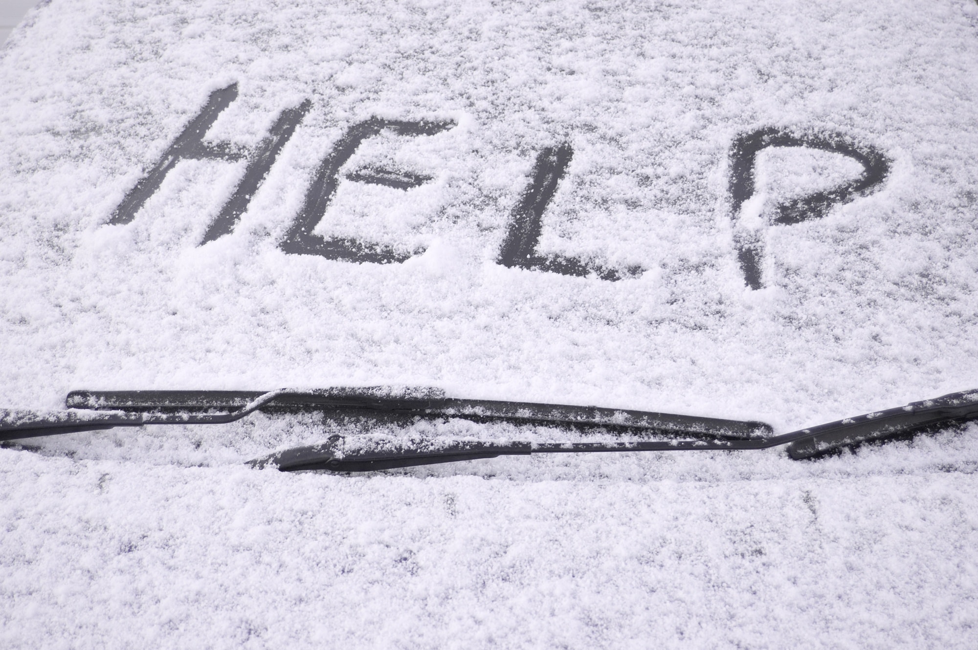 A help sign and brightly covered cloth used as a flag will let other drivers know you are in distress ~ 5 tips to prepare your vehicle for a winter road trip