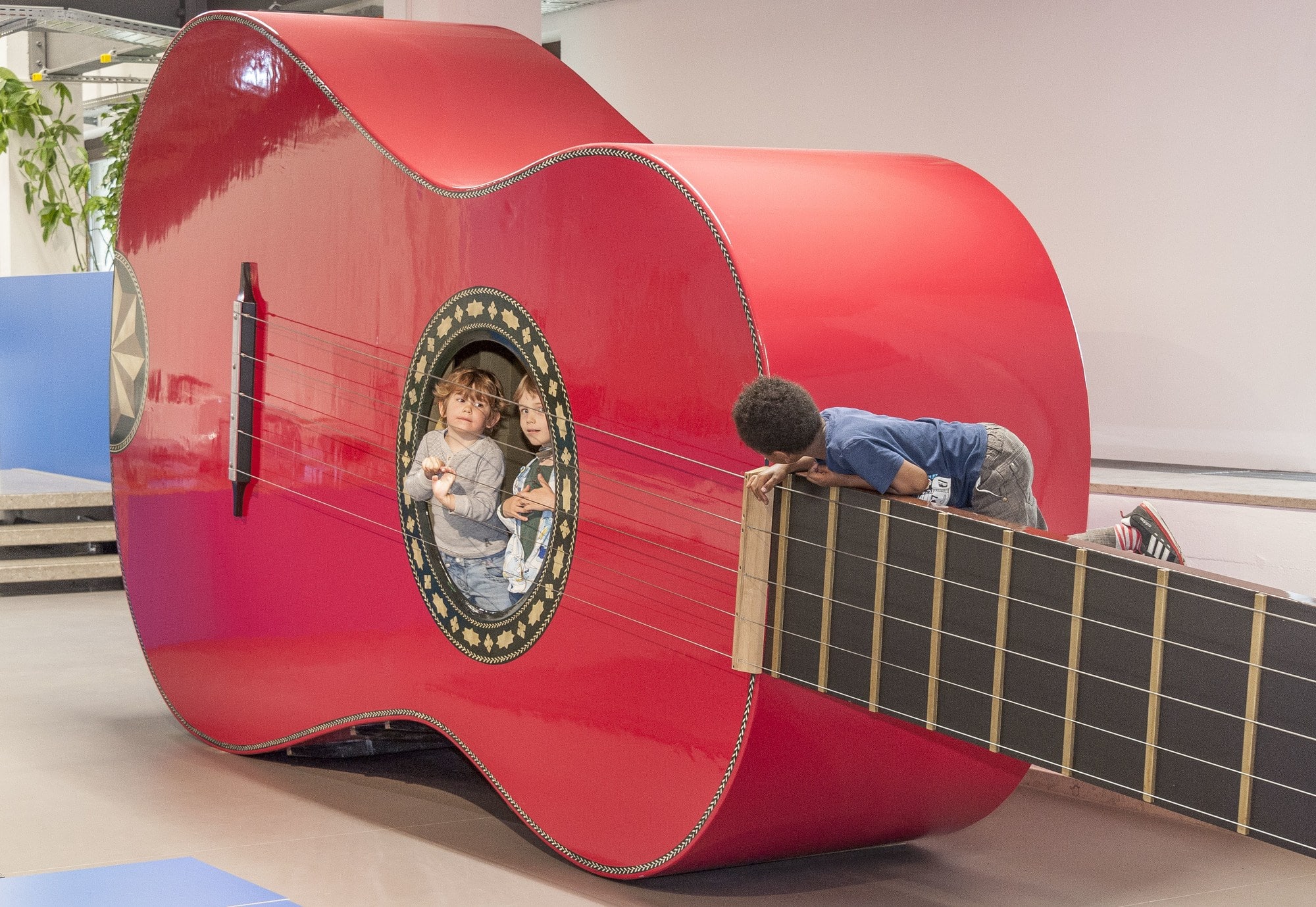 Inside a giant guitar at the Deutsches Museum, kids can find out how it feels when someone plucks the strings ~ Munich with kids