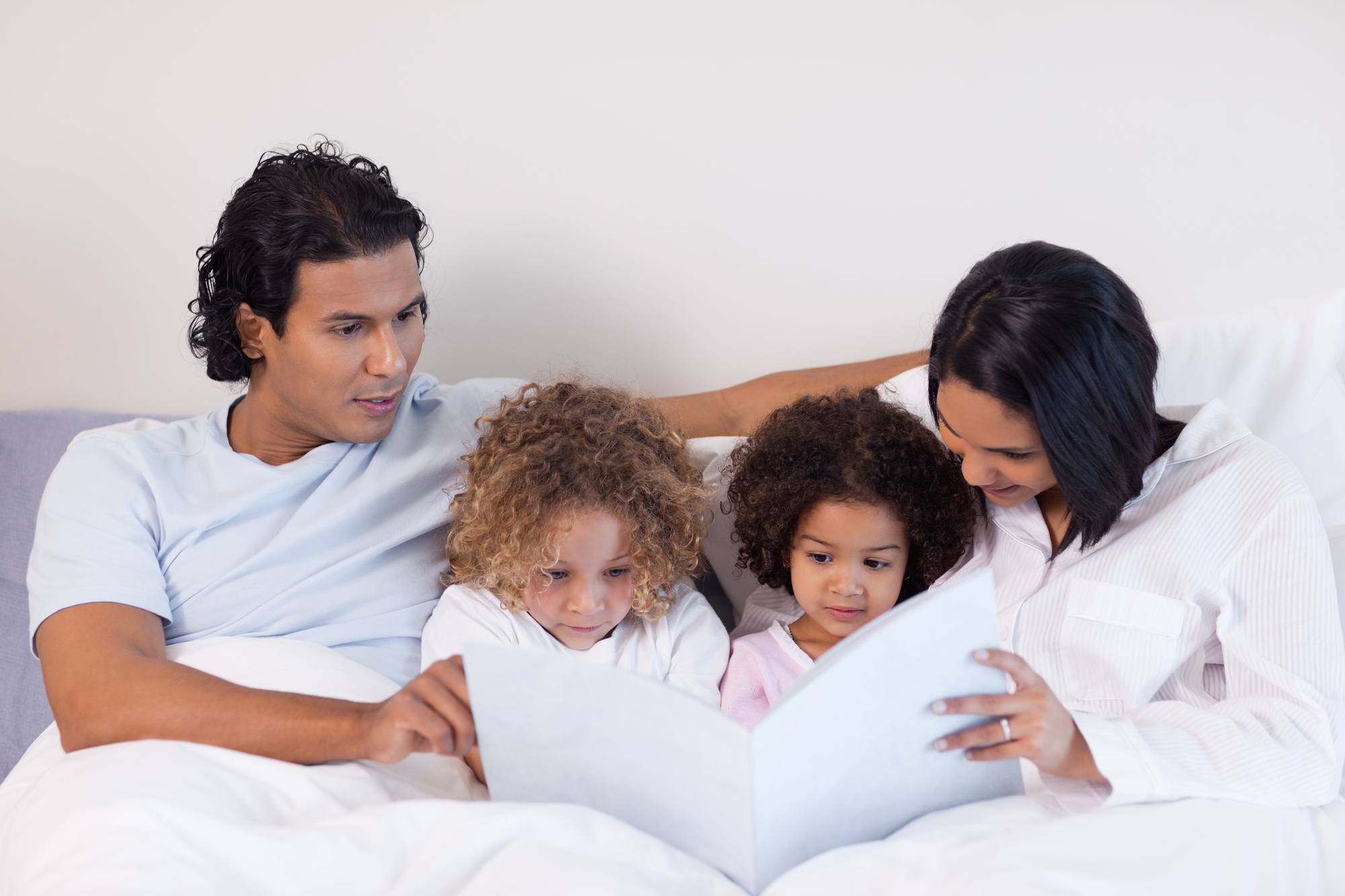 Parents reading a bedtime book to children