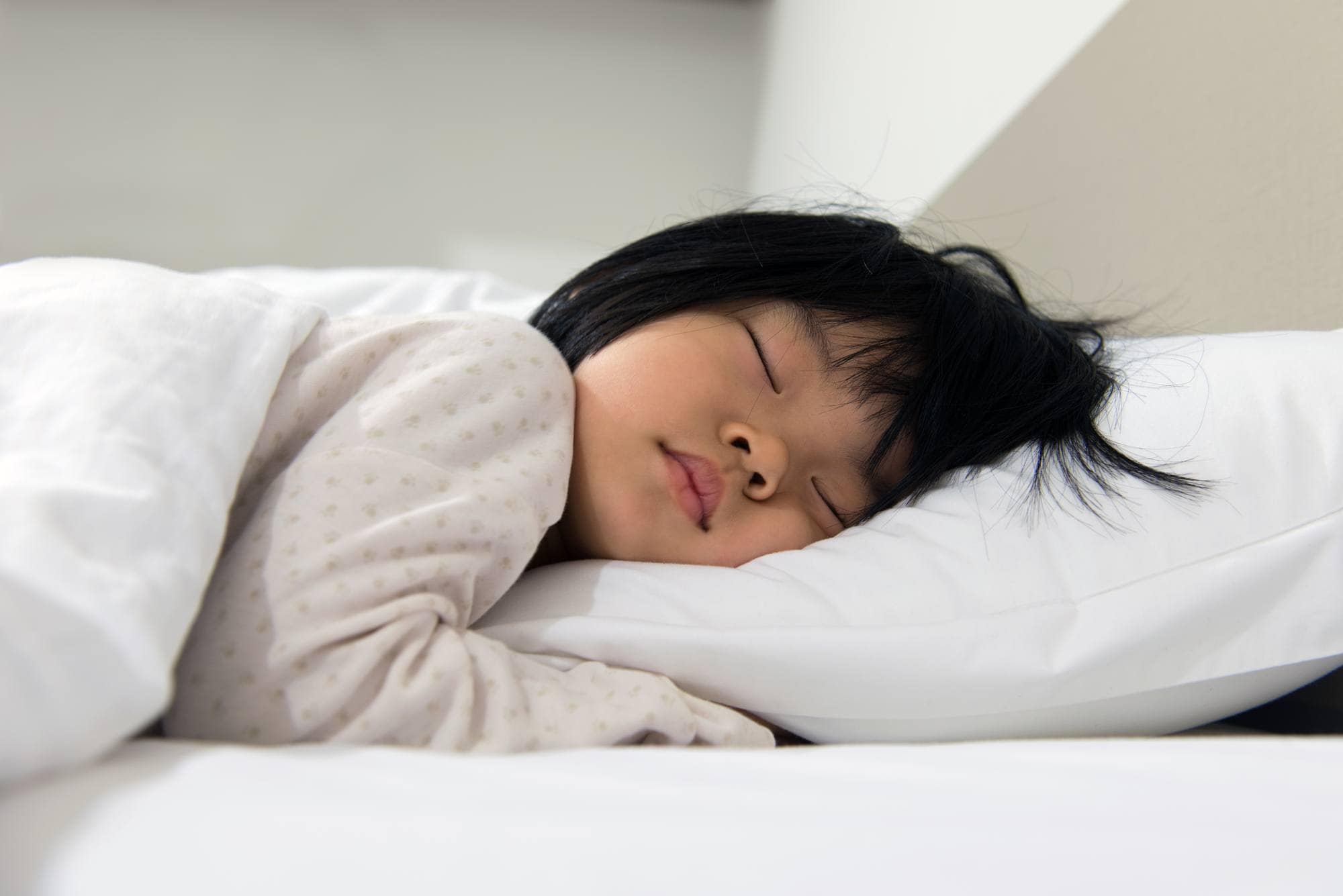 Young child sleeping in bed