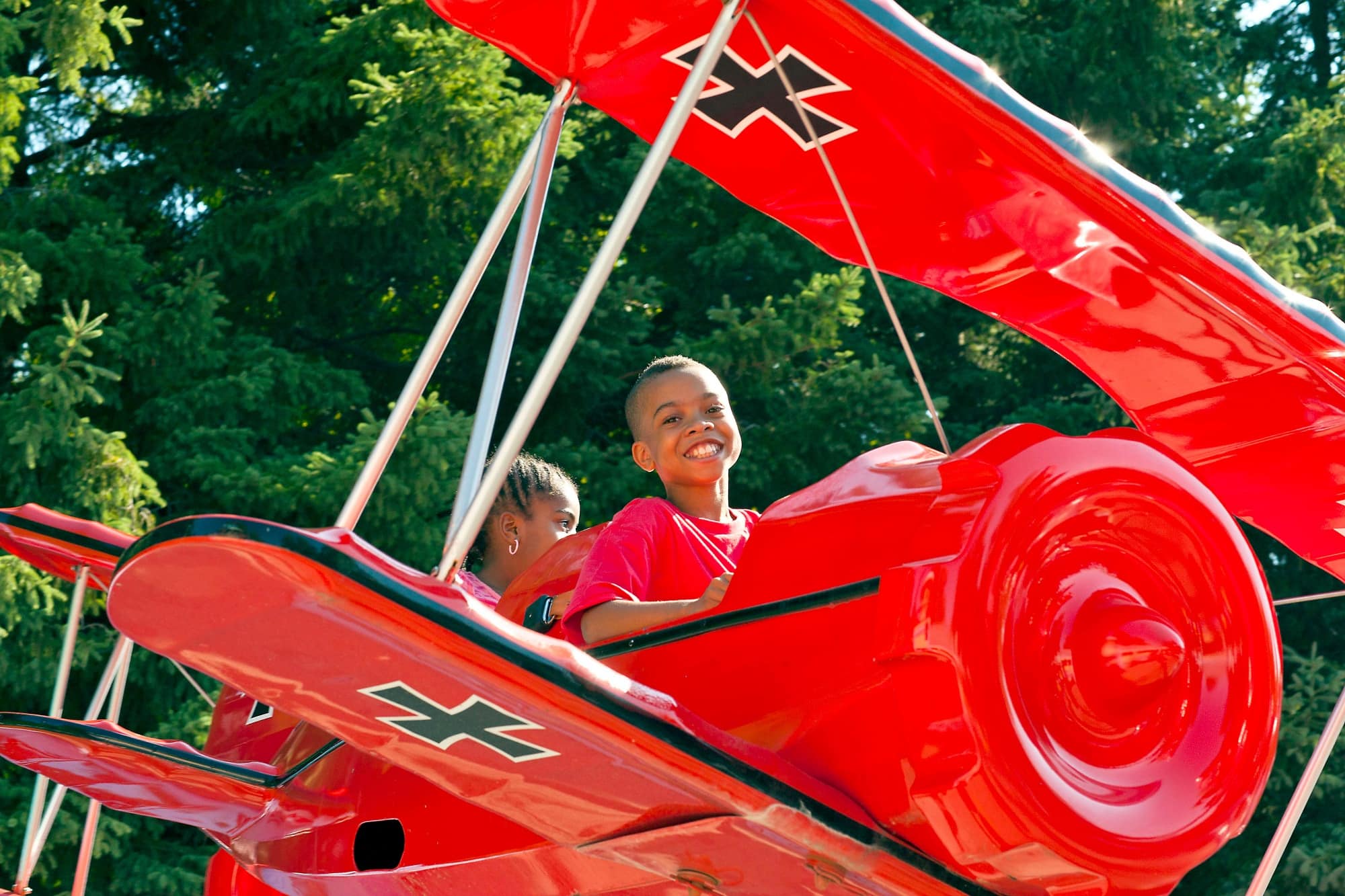 Kids fly in Snoopy vs. Red Baron in Planet Snoopy 