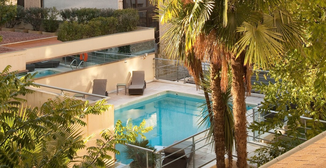 Oceania Le Metropole Montpellier features a palm-lined pool 