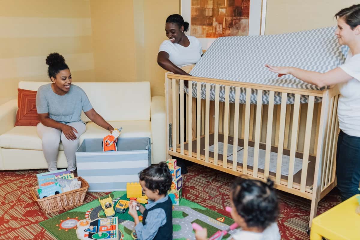 A full-sized crib and other baby equipment helps families enjoy their travels more