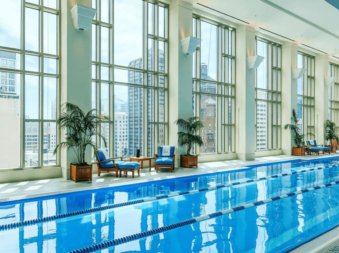 The Peninsula Chicago's indoor pool with a view of the Windy City