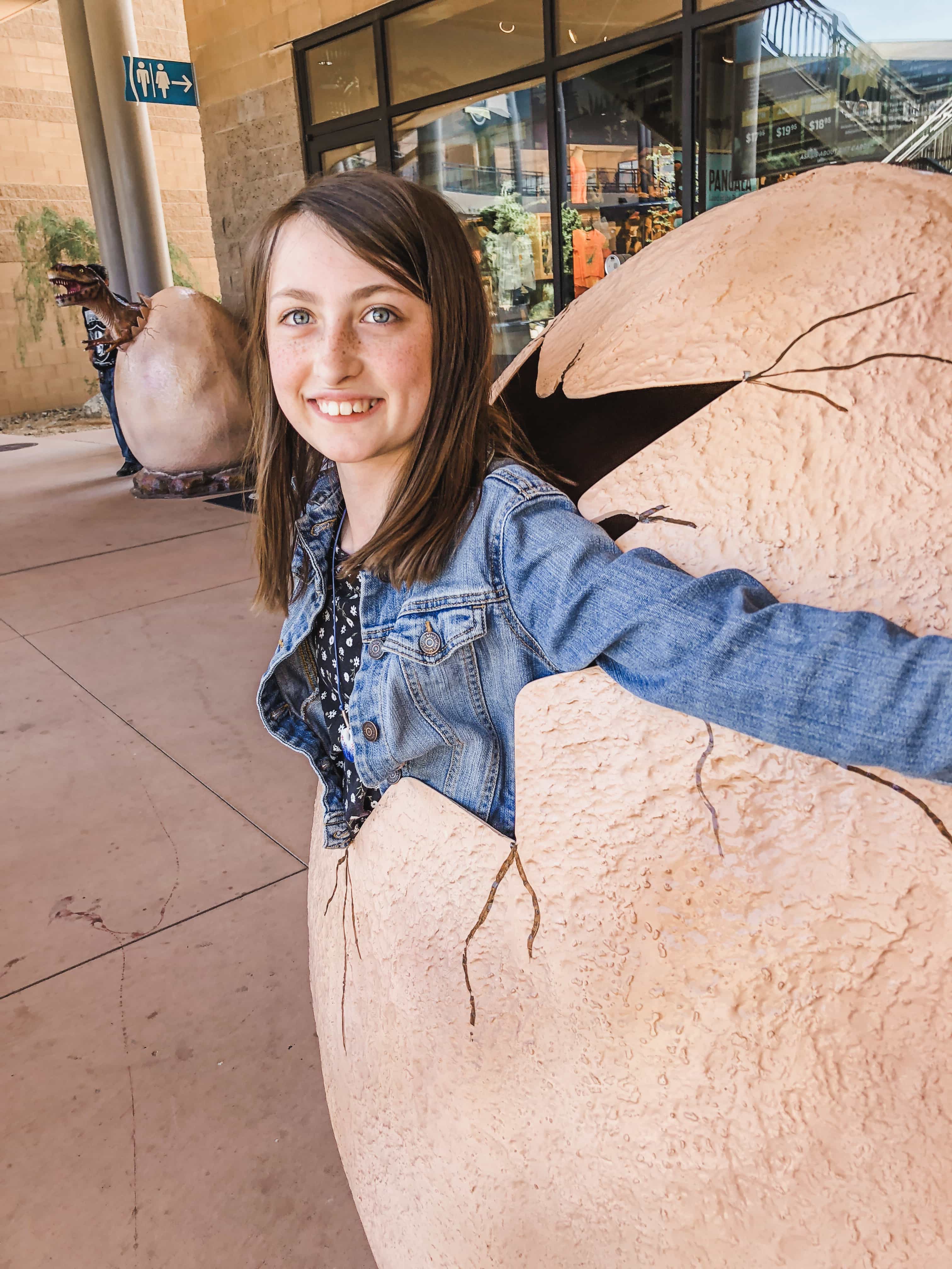 A dinosaur egg photo op outside Pangea Land of the Dinosaurs in Scottsdale with kids