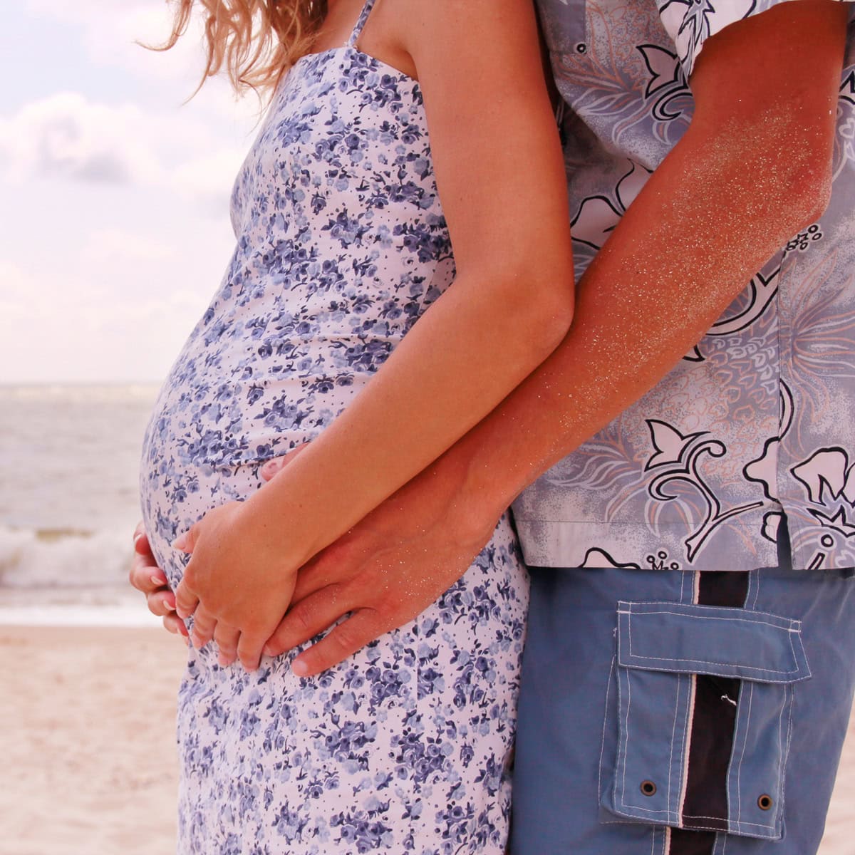 Couple on beach babymoon