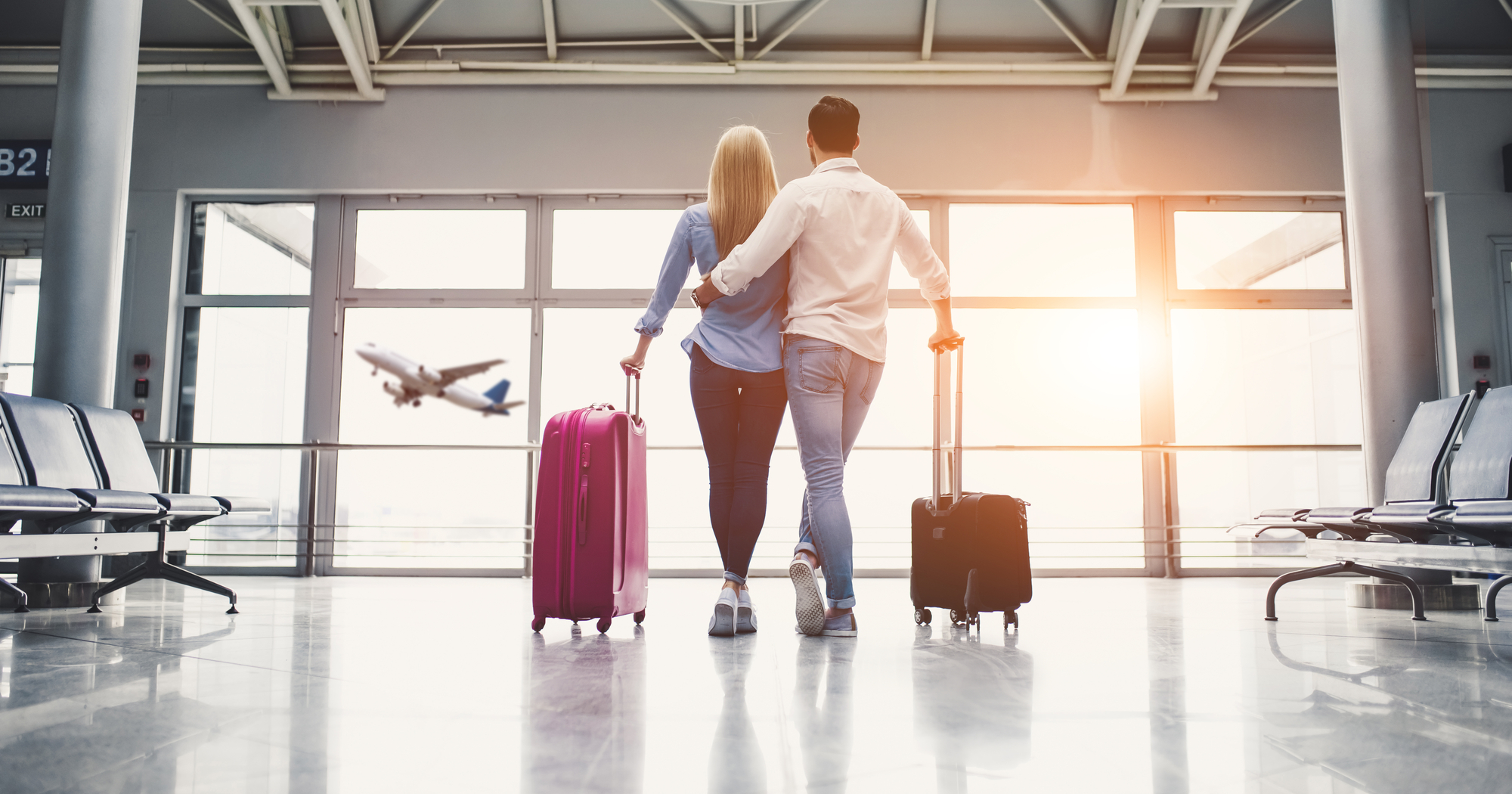 Couple in airport embarking on a romantic getaway