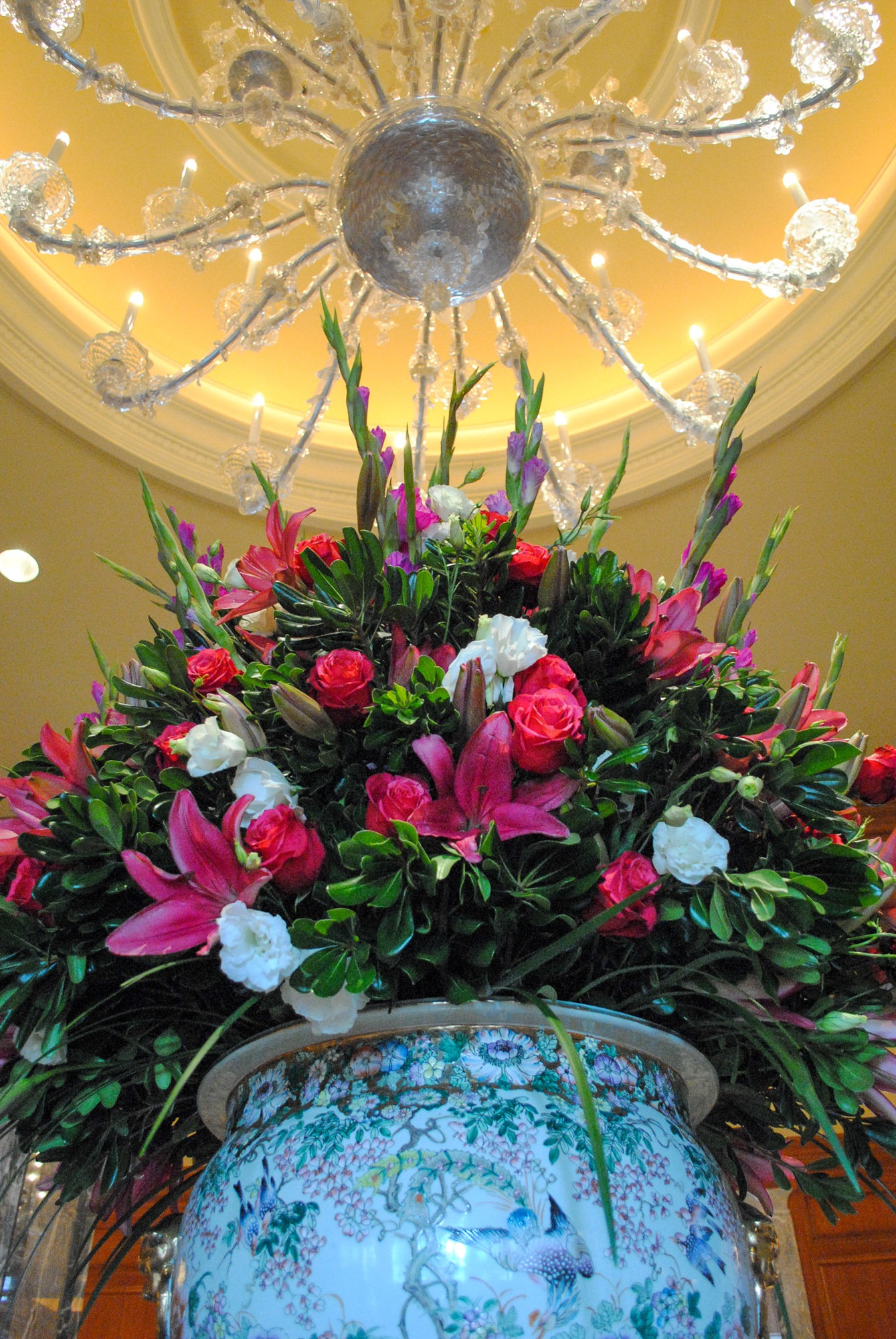 A beautiful flower arrangement below one of Grand America's many hand-blown chandeliers