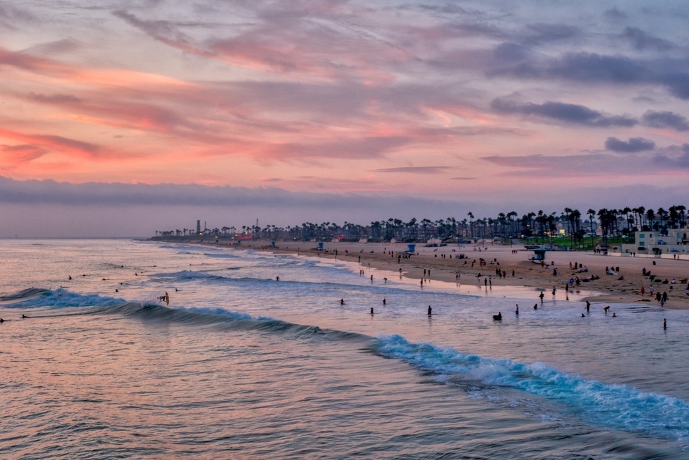 Surfers at sunset in Huntington Beach, CA