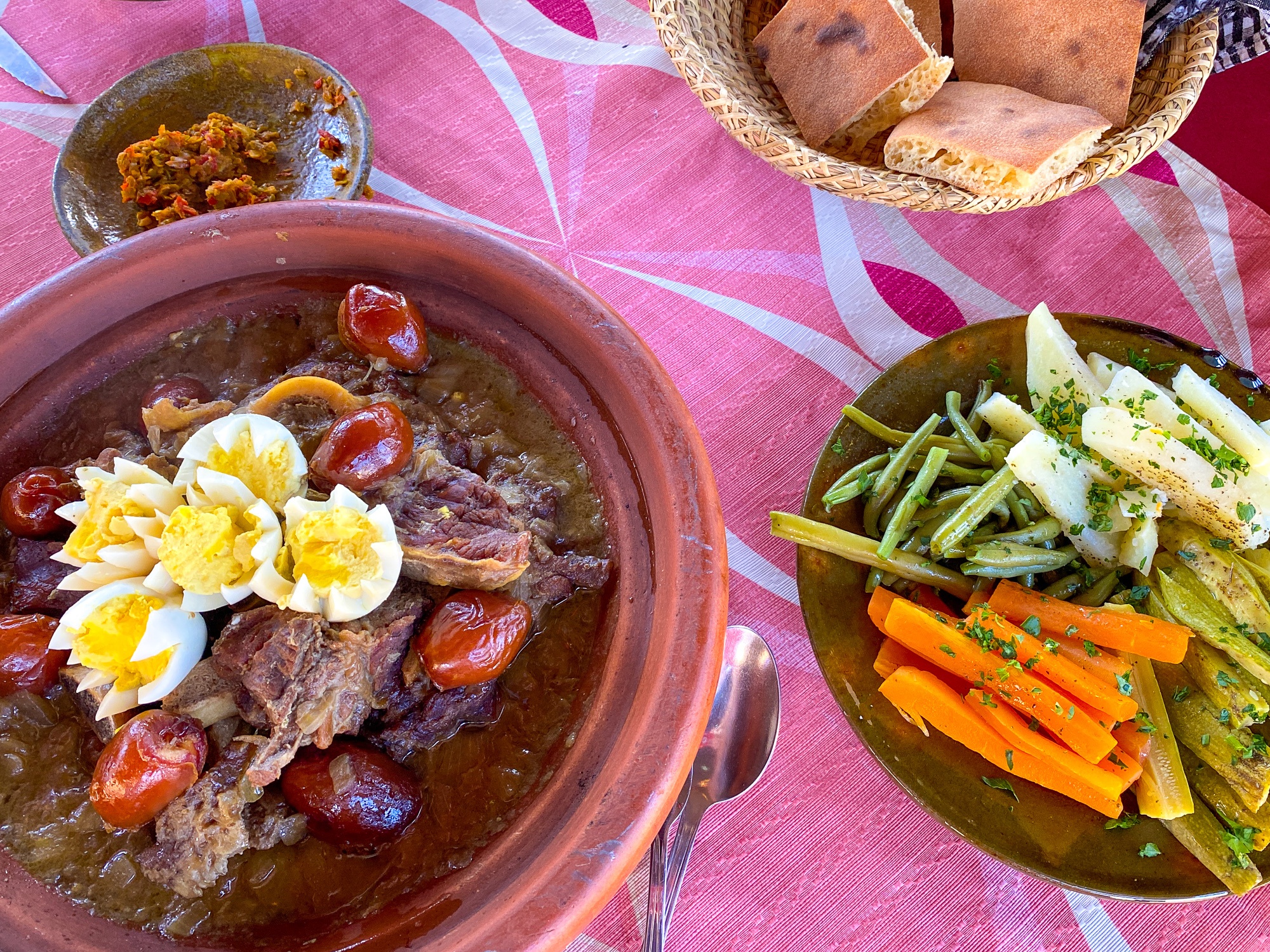 Camel tagine with a side of fresh veggies, harissa, and Morocco’s true staple...bread