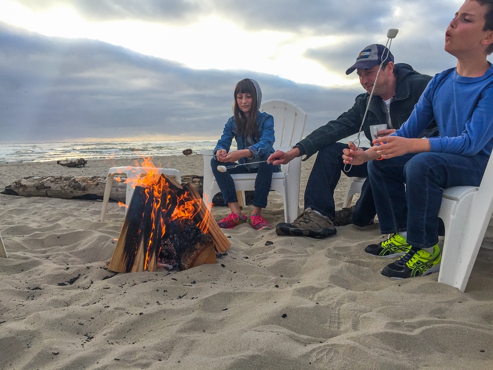 Roasting marshmallows for s'mores at Cannon Beach, Oregon Beach