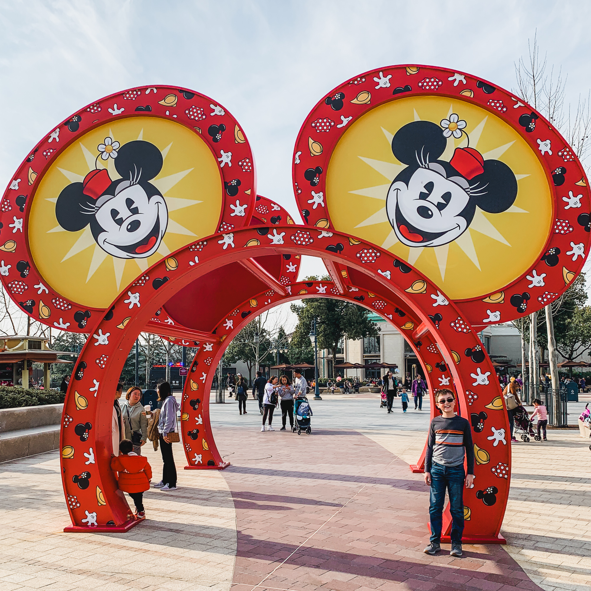 Young boy with Mickey Mouse arches in Shanghai Disneyland's Disneytown