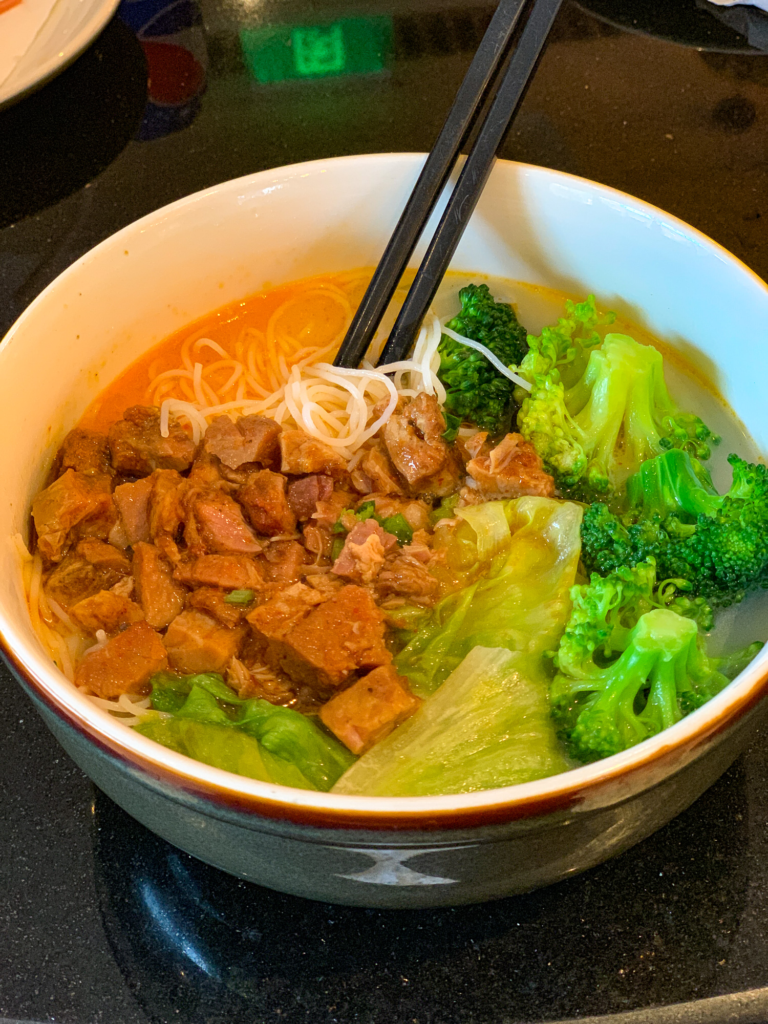 Breakfast soup with spicy pork, rice noodles, broccoli and bok choi from the Dining Room restaurant in Disneytown 