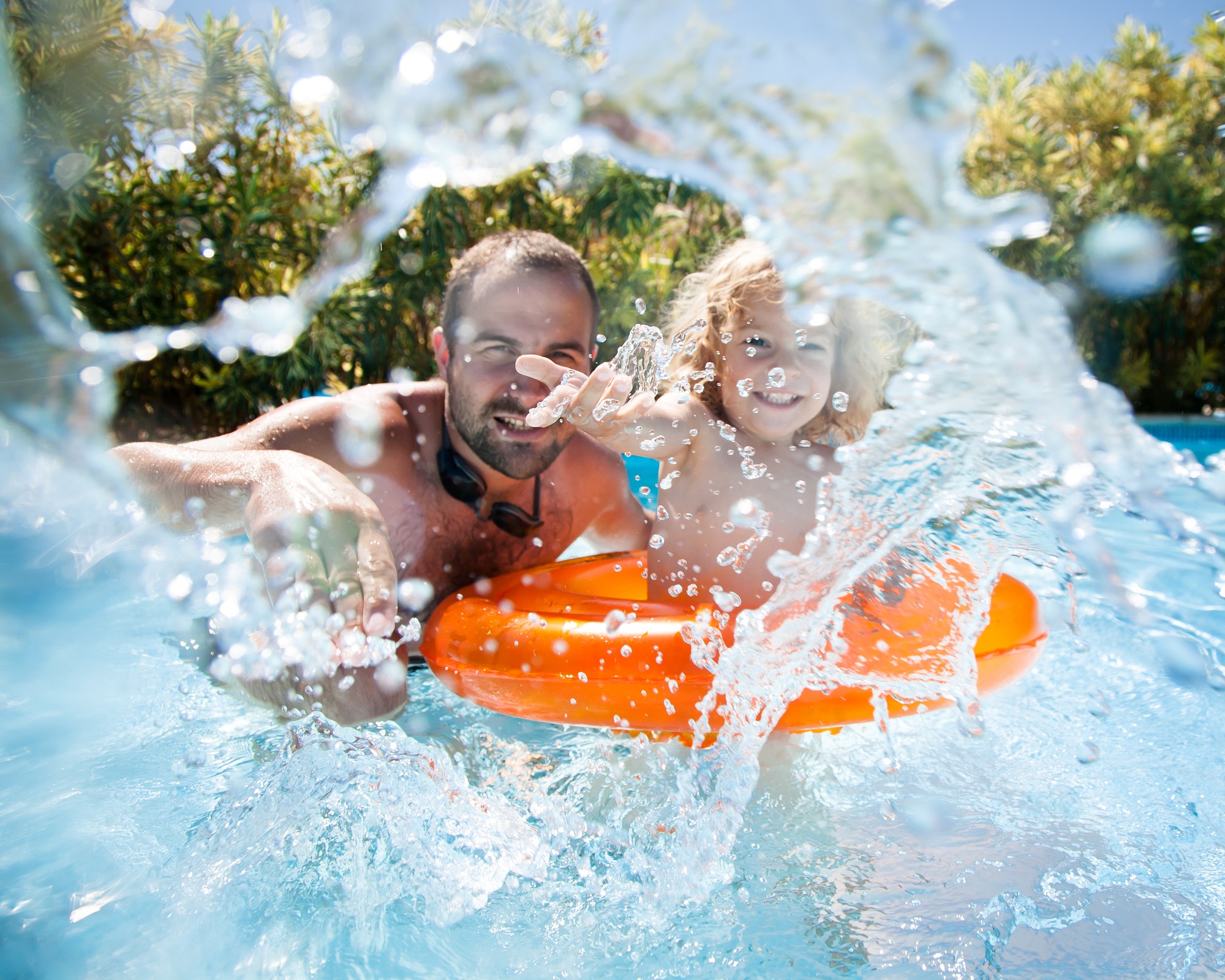 Dad and child swimming together on vacation