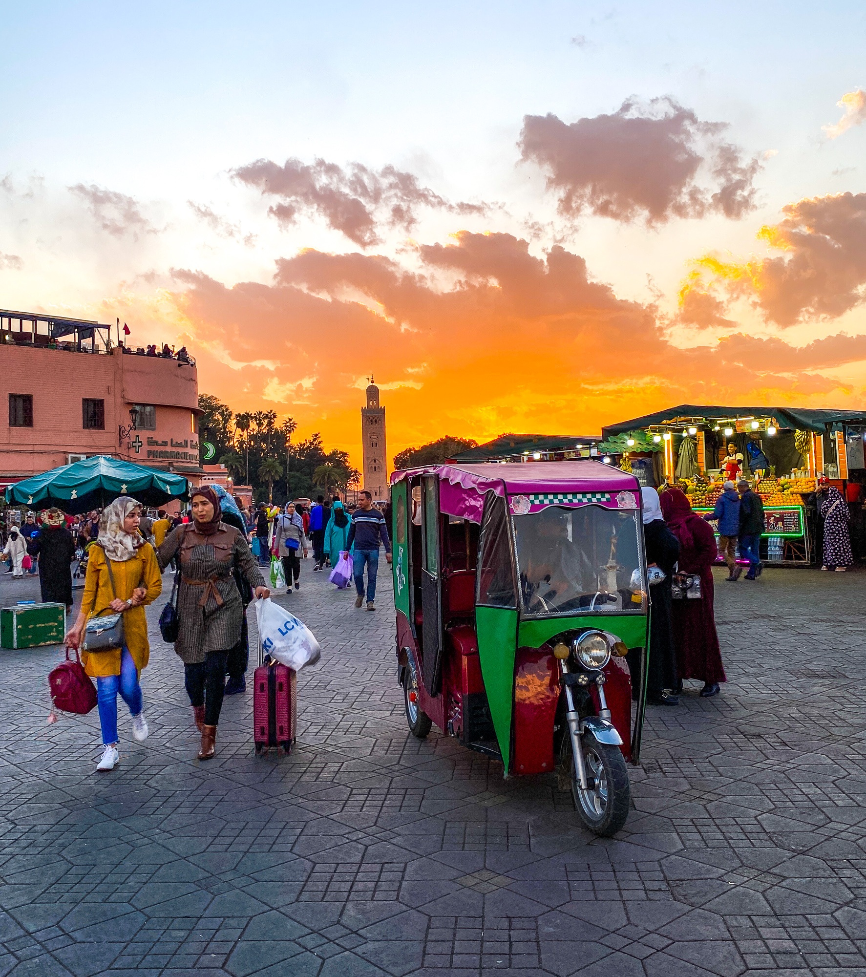 Shoppers and a tuktuk in Marrakech's medina 