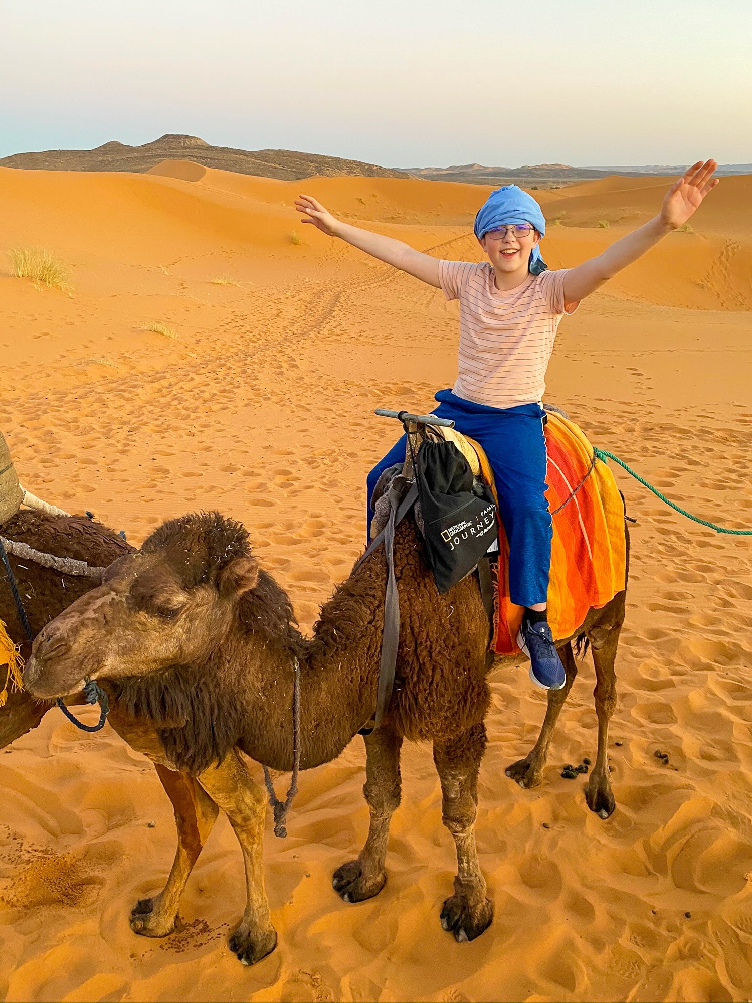 Tween boy on a camel in the Sahara Desert in Morocco