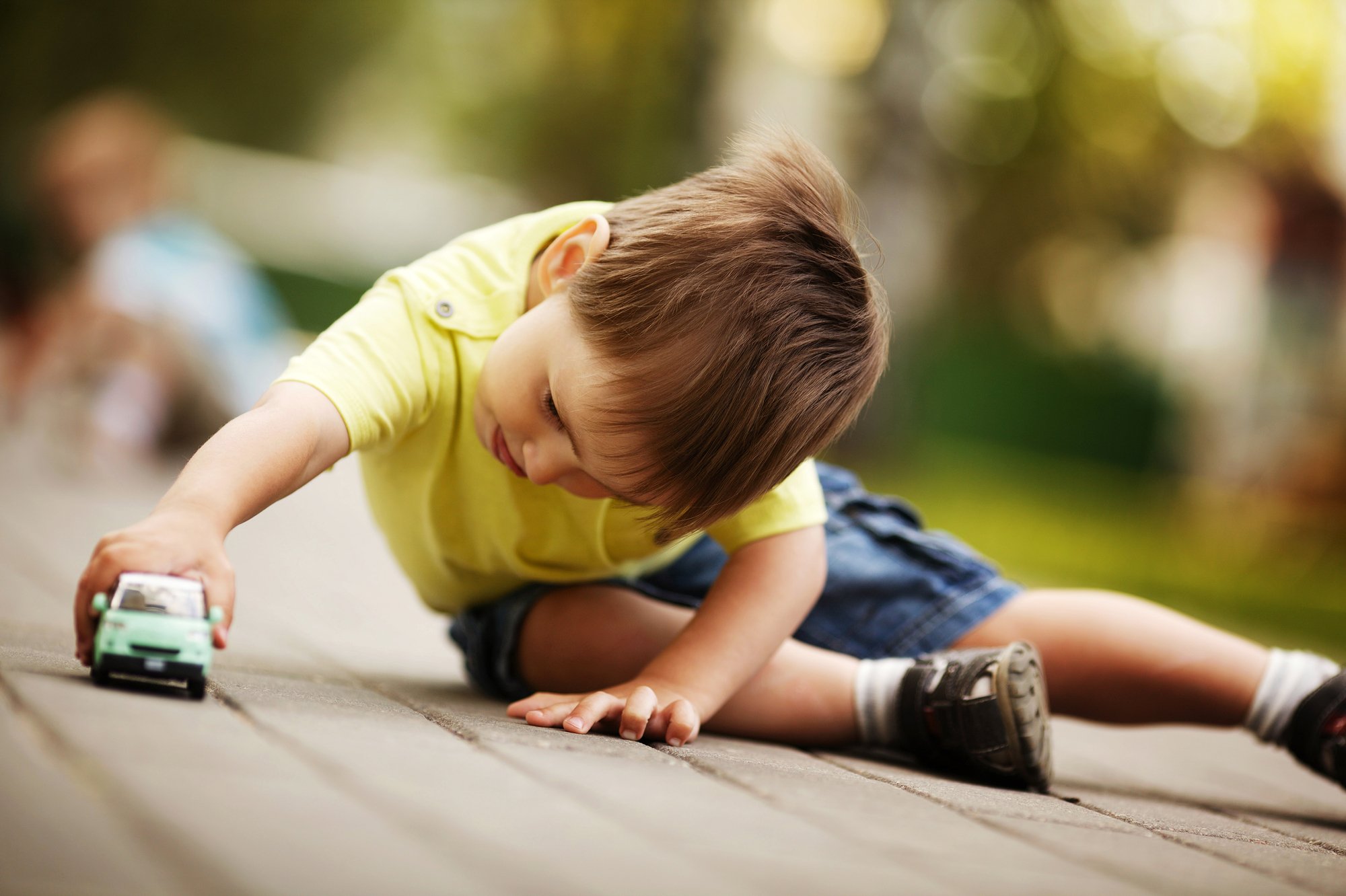 Little boy playing with a toy car