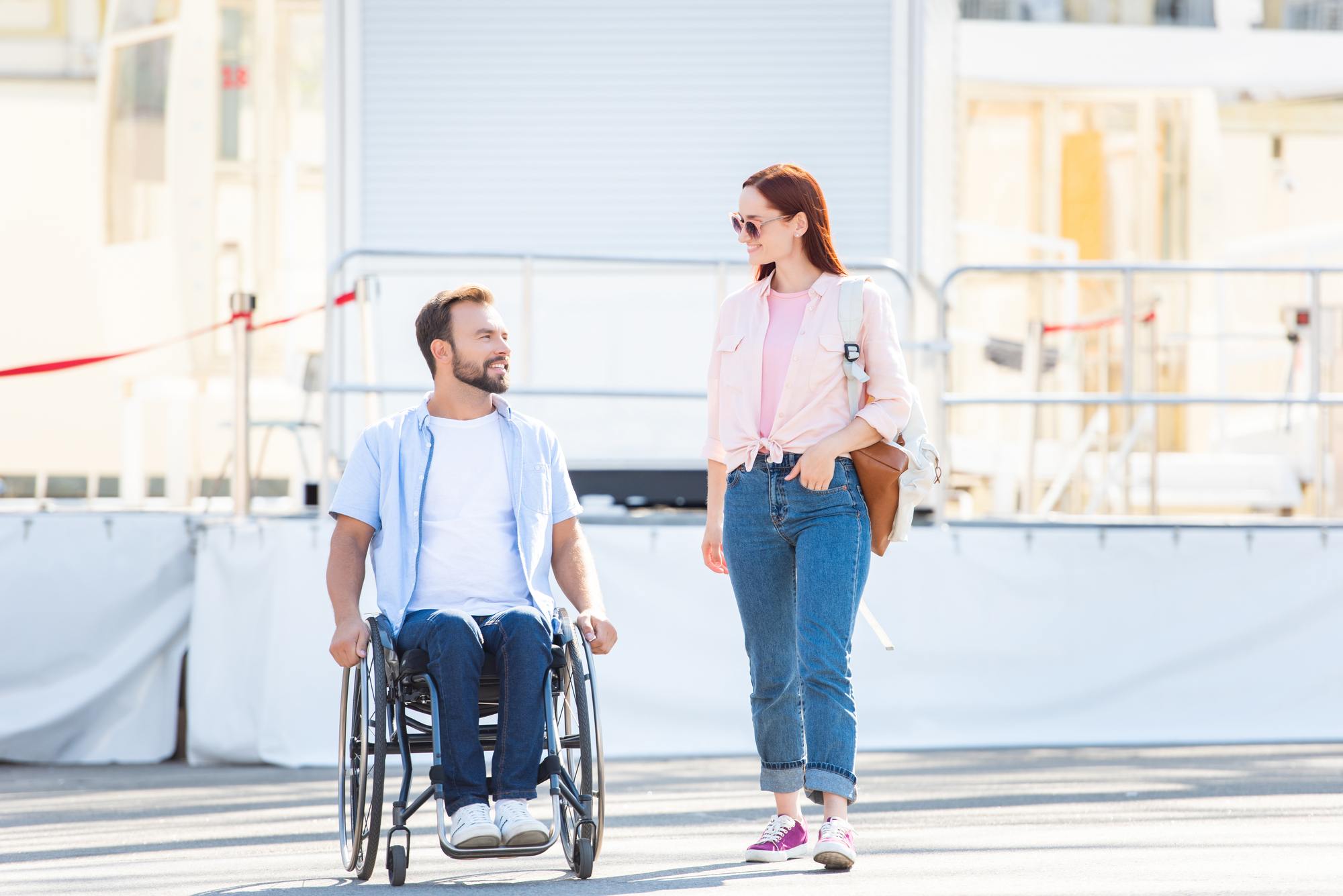 Man in wheelchair with standing woman