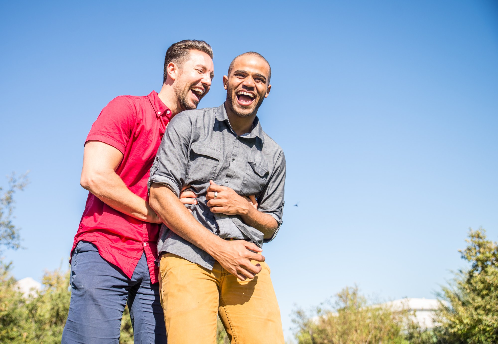 Gay male couple laughing