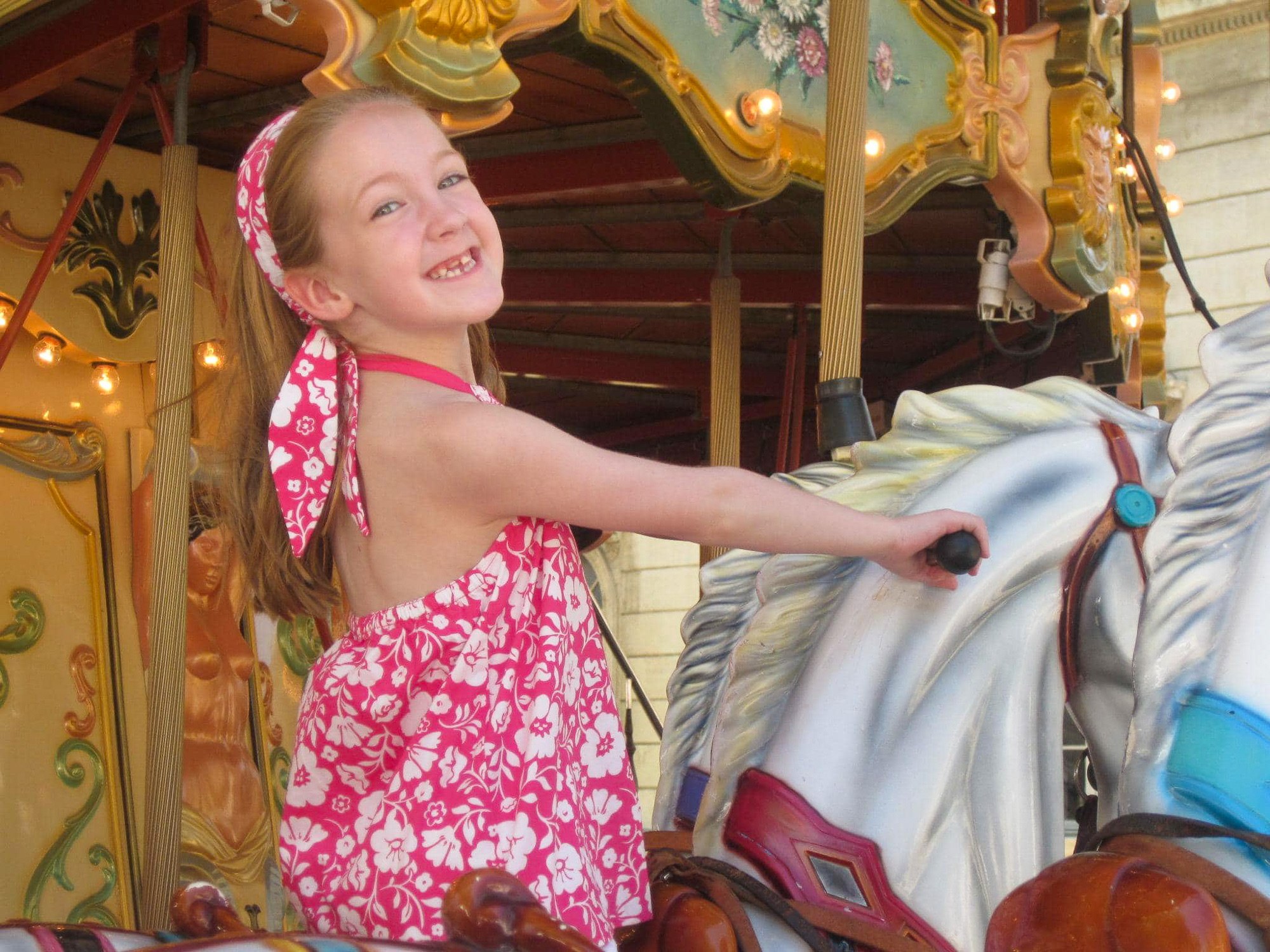 Little girl riding carousel in Provence, France