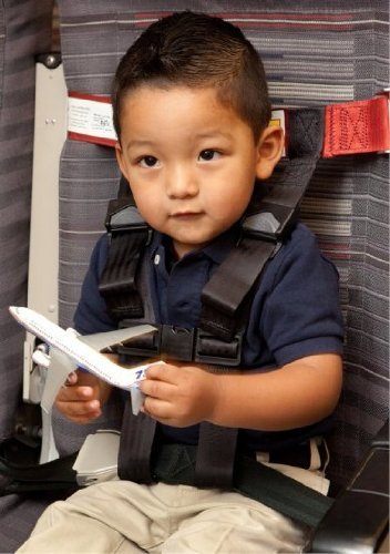 Little boy secured in a CARES kids airplane harness