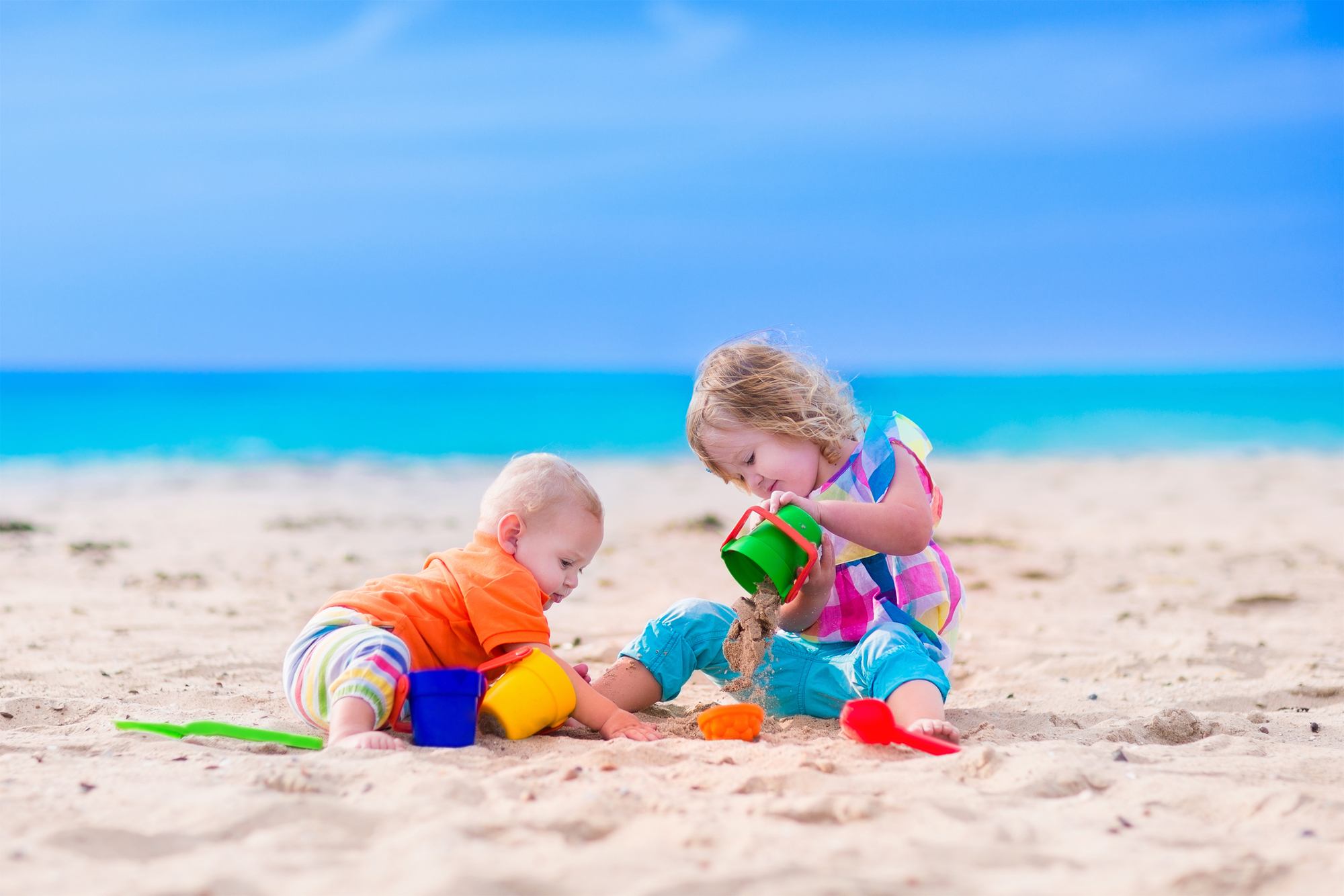 Baby and toddler playing on vacation