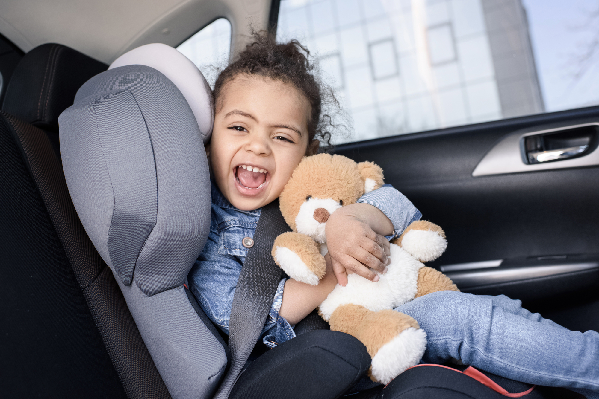 Road trip with a toddler holding a toy