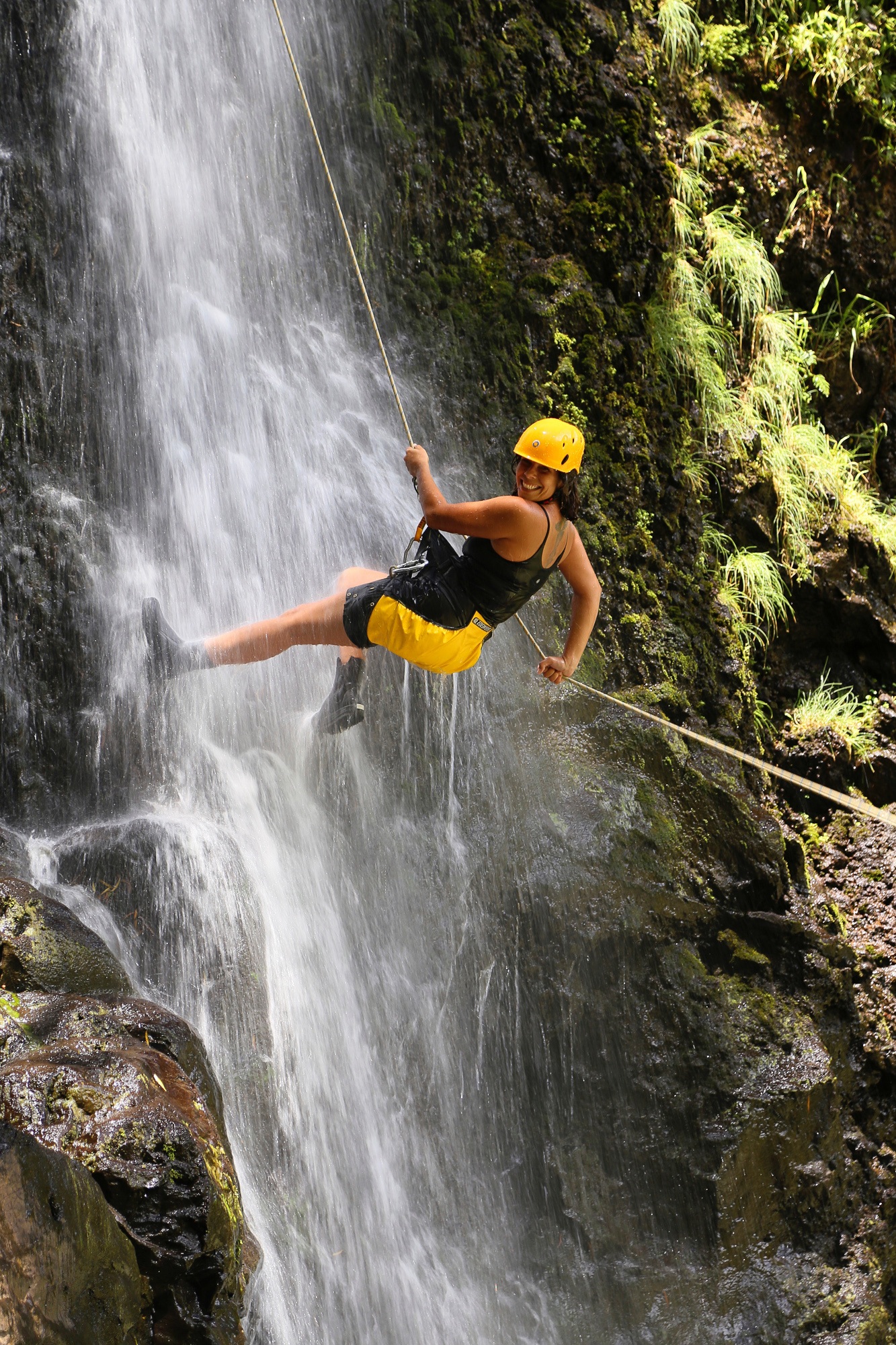 Rappeling down a waterfall in Maui