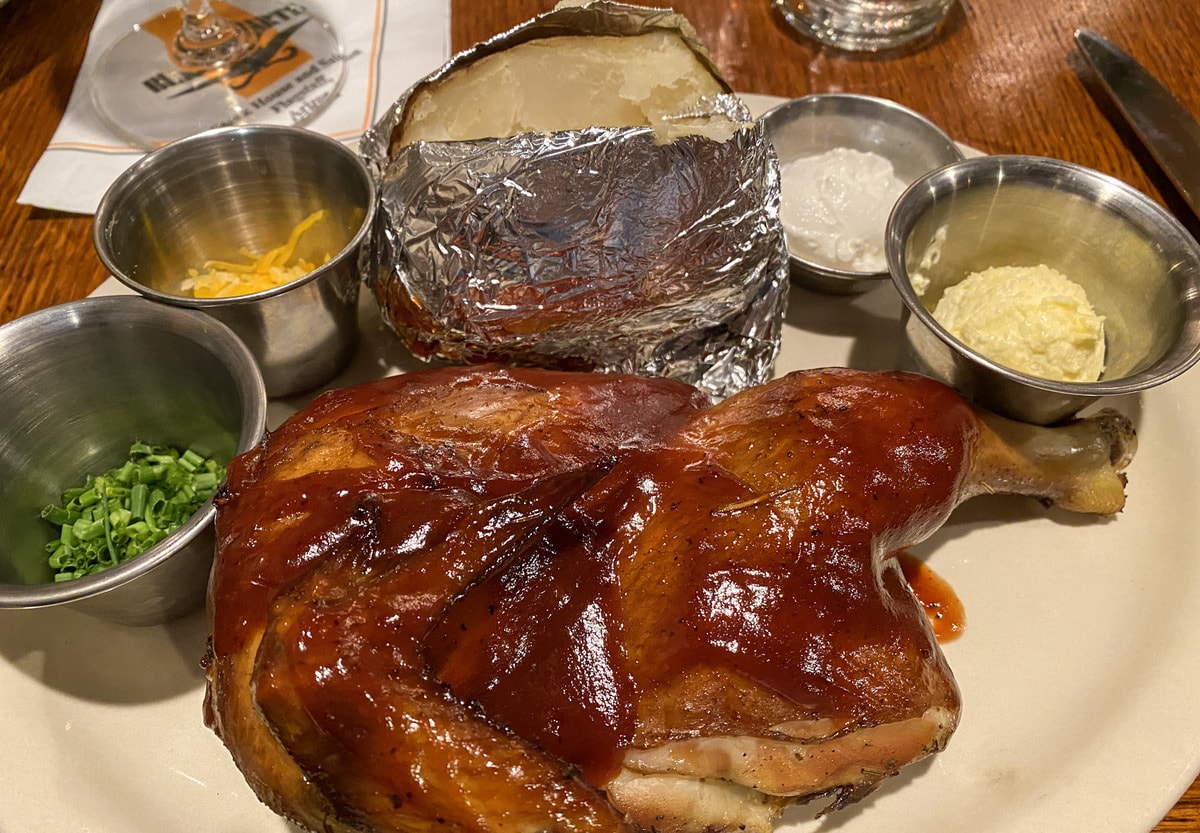 1/4 BBQ chicken with loaded baked potato at Black Bart's Steakhouse 