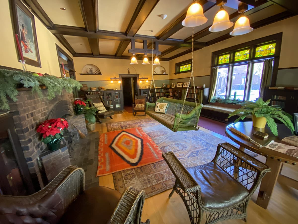 Living room with wicker swing at Riordan Mansion in Flagstaff