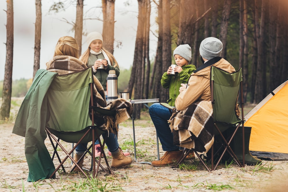 Family at campsite with camp chairs