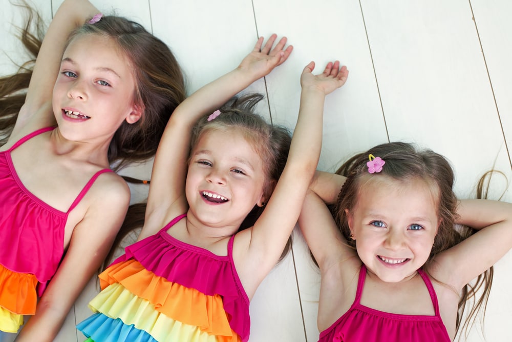 Children dressed in similar, brightly colored outfits