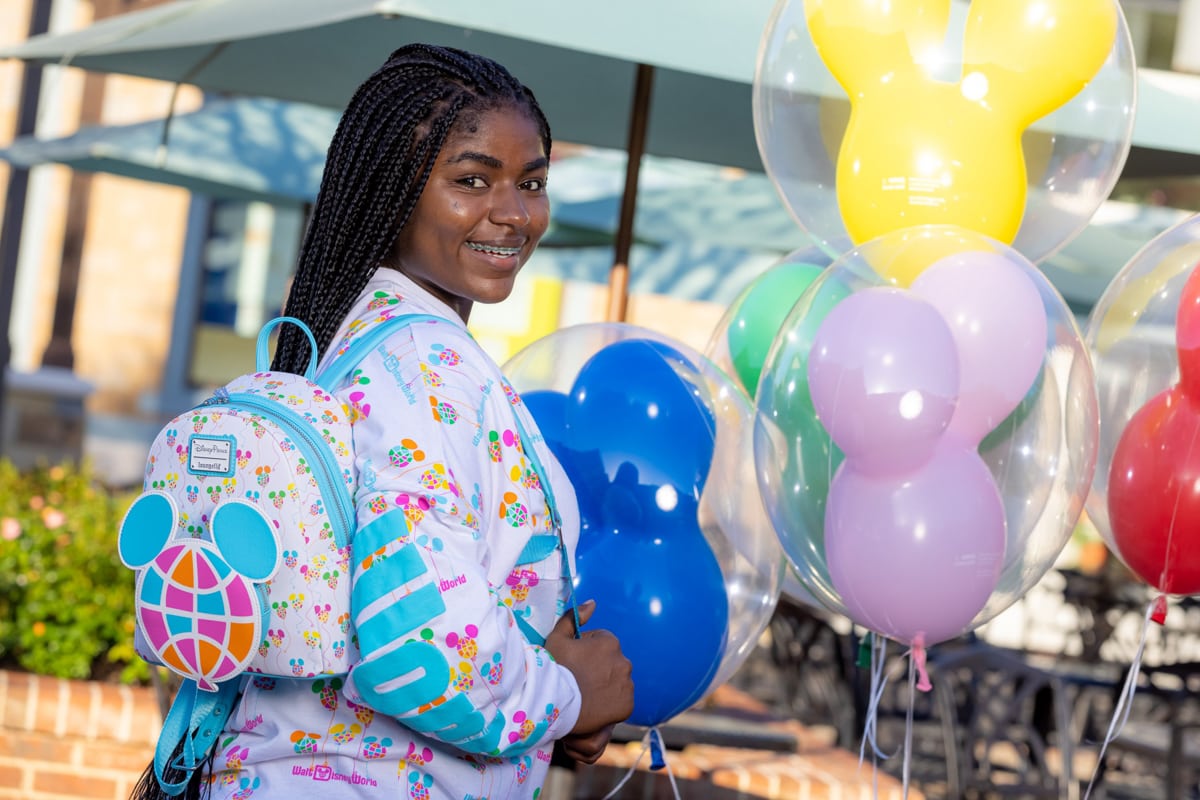 Teen with balloons at Disney World