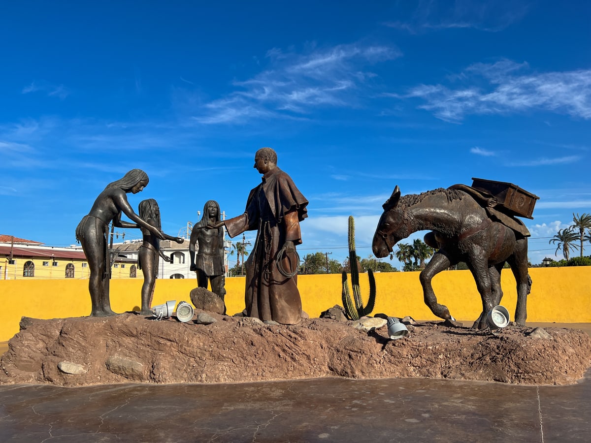 Statue of Catholic priest with indigenous people of Loreto