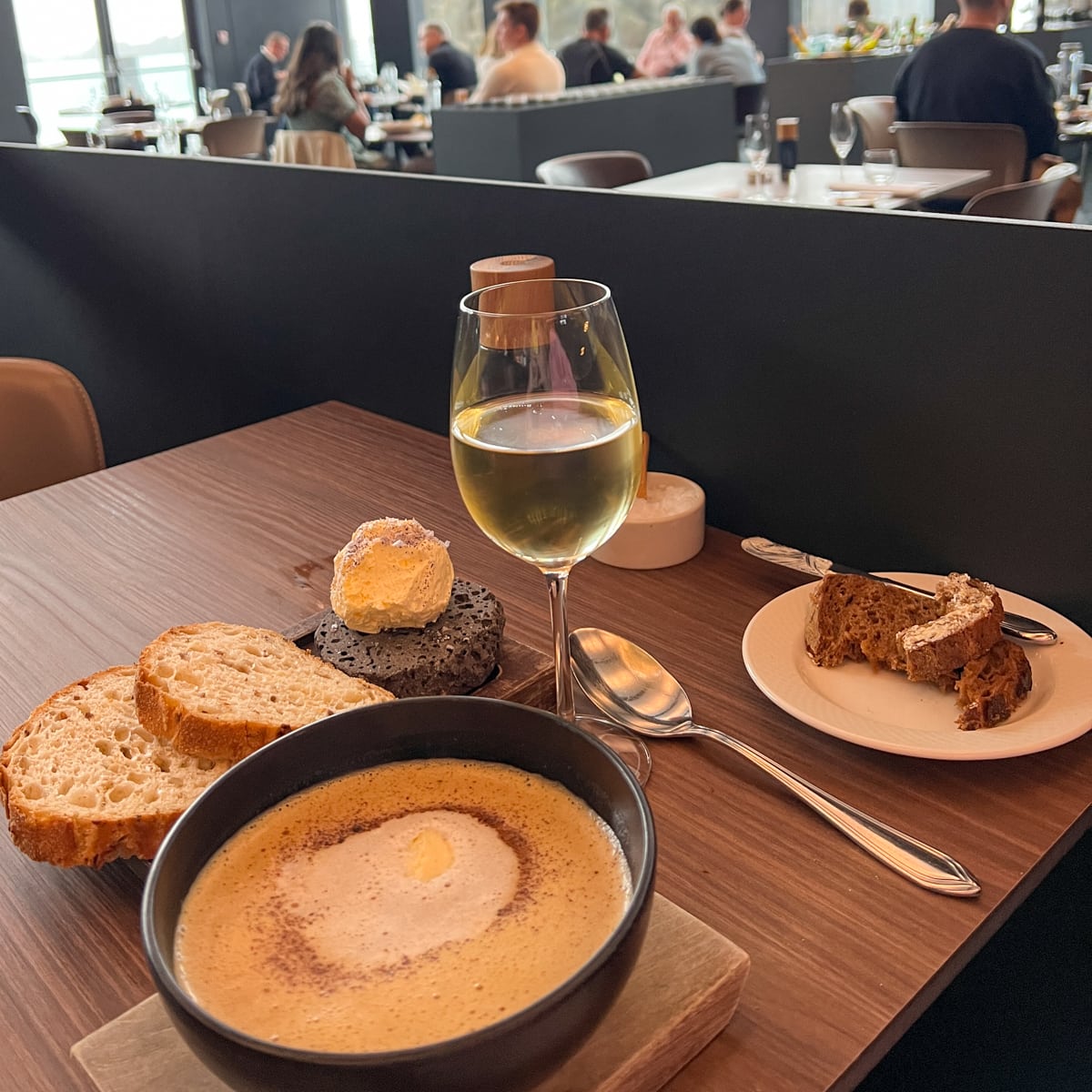 Lobster bisque, bread, and wine at Lava Restaurant