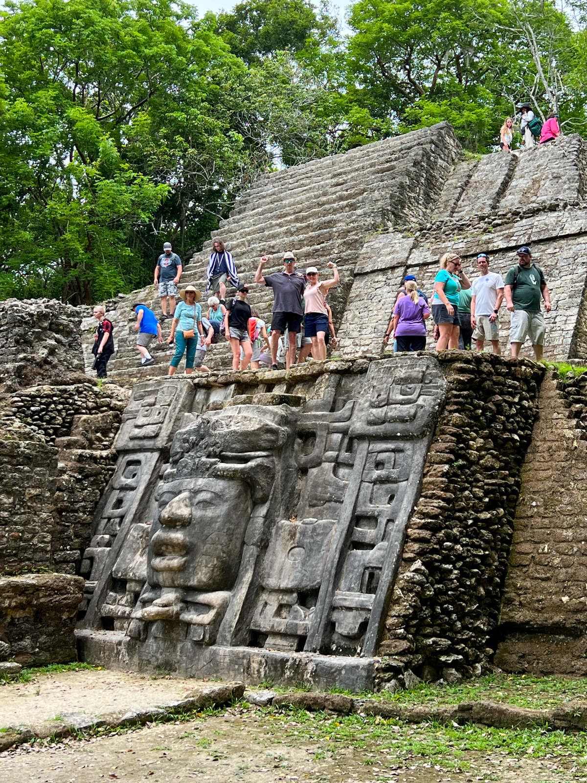 My husband and I flexing on Mask Temple at Lamanai Mayan Ruins in Belize