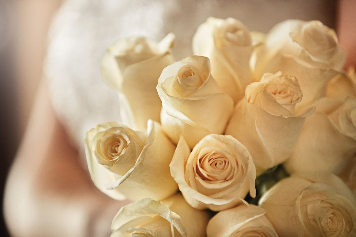 A bridal bouquet of fresh roses is included with Princess Perfect Weddings