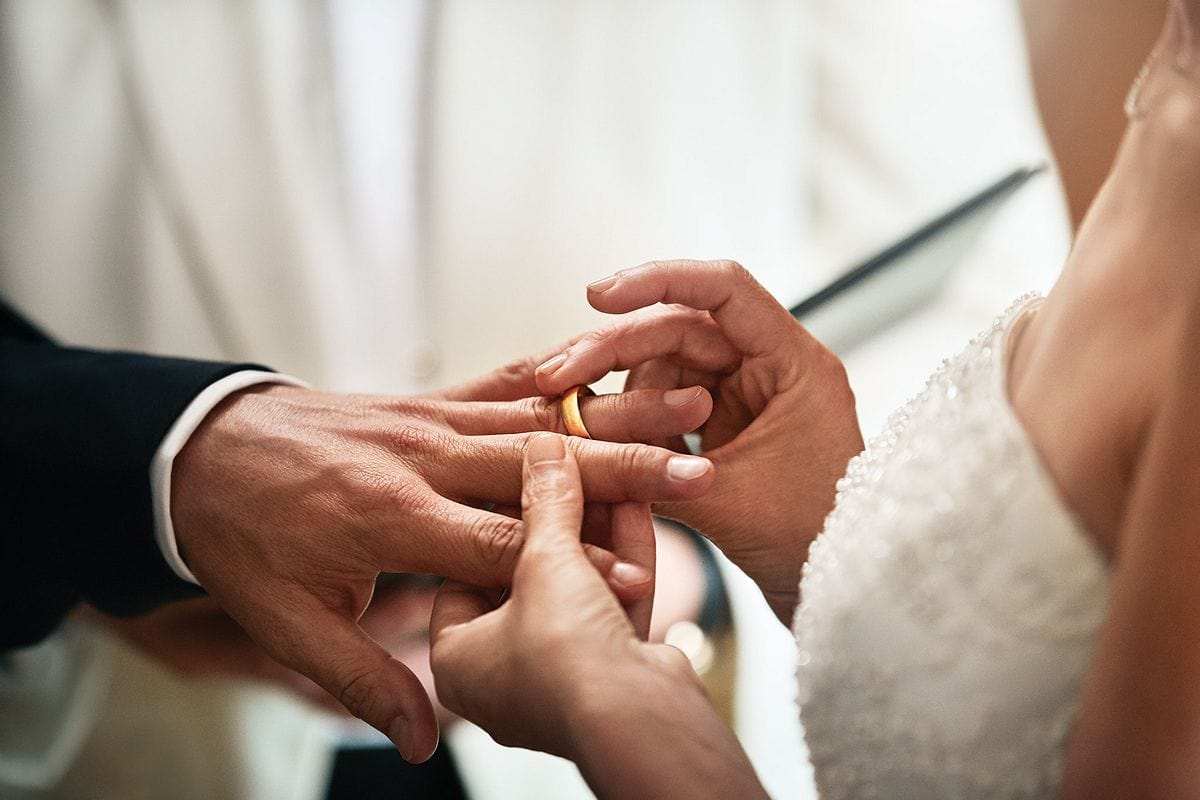 Bride and groom exchanging wedding rings on a Princess Cruise