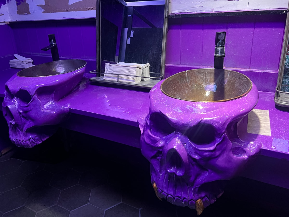 Skull-shaped sinks in the restroom at Cocktails & Screams Bar in Orlando